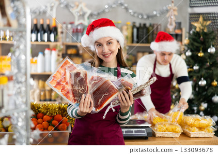 Woman seller offering jamon and meat 133093678