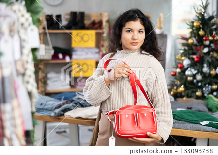 Latina chooses a handbag in a New Year store 133093738