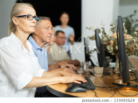 Computer literacy lessons in nursing home for elderly. Mature woman at computer Computer literacy lessons in nursing home for elderly. Mature woman at computer 133093829