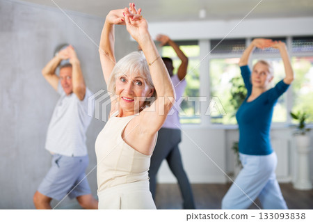 Senior lady enjoying flamenco during group dance class 133093838