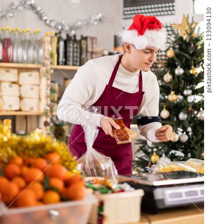 Male salesman behind a grocery counter Male salesman behind a grocery counter 133094130