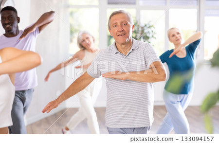 Mature men and women practicing Hip-hop dance in training hall Mature men and women practicing Hip-hop dance in training hall 133094157