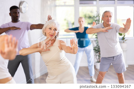 Mature men and women practicing Hip-hop dance in training hall 133094167