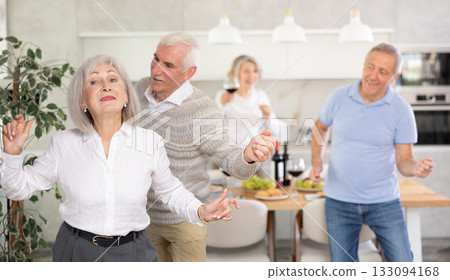 Couple of elderly man and woman dancing in kitchen 133094168