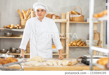 Young guy standing in bakehouse, ready to start baking 133094195