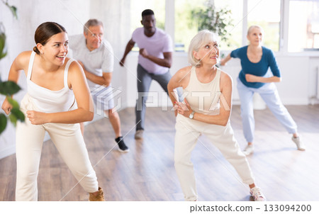 Men and women of different ages practicing Hip-hop dance in training hall Men and women of different ages practicing Hip-hop dance in training hall 133094200