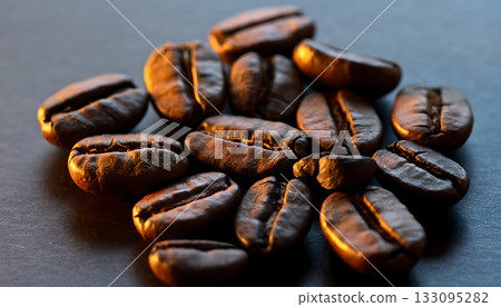 Pile of roasted brown coffee beans close up creating a warm and inviting aroma for morning freshness 133095282