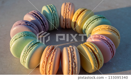 Pastel macarons circle on stone surface creating artistic sweet arrangement delicious colorful 133095340