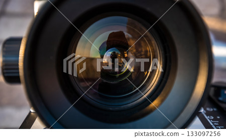 Intricate patterns of light and reflection: a close-up view into the lens of a camera capturing a Intricate patterns of light and reflection: a close-up view into the lens of a camera capturing a 133097256