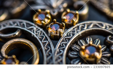 Intricate adornments featuring jewel toned accents, create an elaborate and luxurious jewelry 133097605