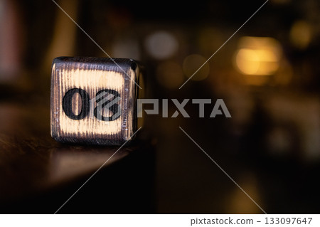 The number 08 on the wooden cube is burned with large symbols. The number 08 on the wooden cube is burned with large symbols. 133097647