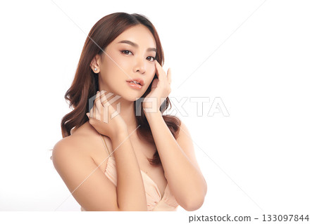 A beautiful young Asian woman with clean, fresh skin against a white background. Skincare, facial treatment, cosmetology, beauty, and spa. An elegant portrait of an Asian woman. 133097844