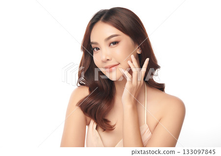 A beautiful young Asian woman with clean, fresh skin against a white background. Skincare, facial treatment, cosmetology, beauty, and spa. An elegant portrait of an Asian woman. 133097845