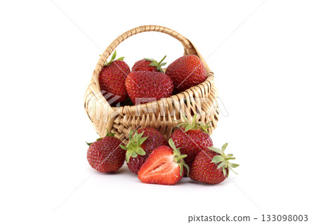 Fresh strawberries spilling from wicker basket on white background Fresh strawberries spilling from wicker basket on white background 133098003
