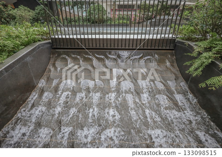 Oct 29 2025 Urban Water Feature With Tiered Stone Surface, Metal Fence Oct 29 2025 Urban Water Feature With Tiered Stone Surface, Metal Fence 133098515