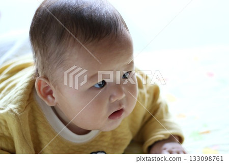 6-month-old baby playing on his stomach 133098761