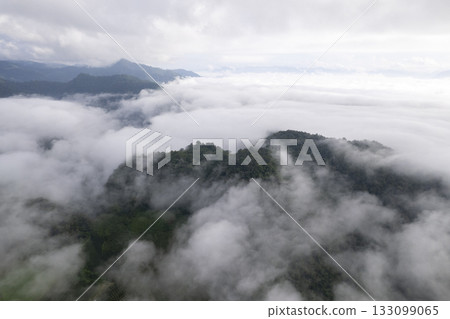 Landscape of Morning Mist with Mountain Layer. mountain ridge and clouds in rural jungle bush forest Landscape of Morning Mist with Mountain Layer. mountain ridge and clouds in rural jungle bush forest 133099065