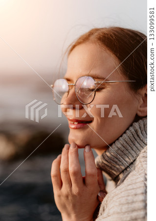 Woman Glasses Beach Sunset: Peaceful autumn seaside relaxation portrait. 133099581