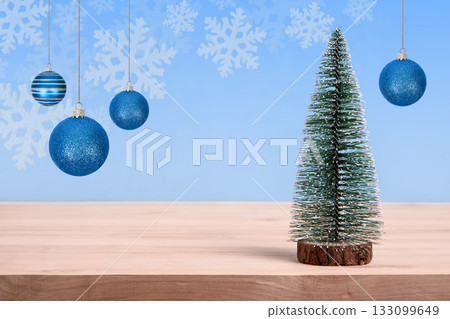 Christmas background with green tree and turquoise Christmas balls on a wooden table. Christmas and New Year design holiday card 133099649
