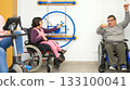 People in wheelchairs doing rehabilitation exercises in a clinic 133100041