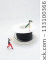 Miniature Figure Balances on a Spool of Black Cable, 133100366