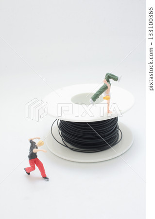 Miniature Figure Balances on a Spool of Black Cable, Miniature Figure Balances on a Spool of Black Cable, 133100366