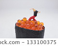 Miniature Figure Doing Handstand on Orange Fish Roe 133100375