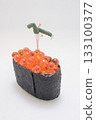 Miniature Figure Doing Handstand on Orange Fish Roe 133100377