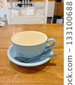 Cafe latte in a blue cup on a wooden table 133100688