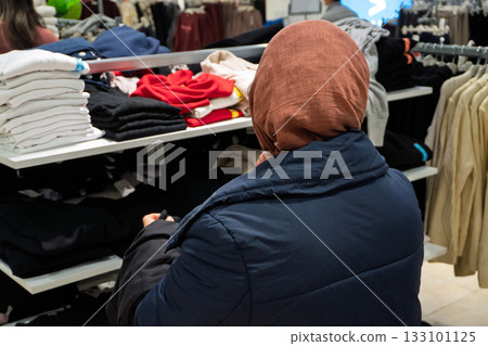 Person Shopping for Clothes in Store Person Shopping for Clothes in Store 133101125