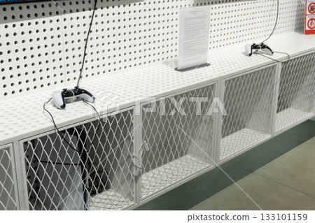 Gaming controllers on white mesh cabinet Gaming controllers on white mesh cabinet 133101159