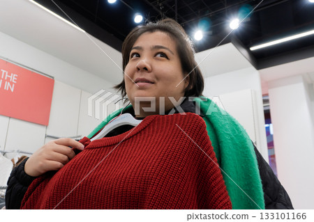 Woman Shopping for Clothes in Store Woman Shopping for Clothes in Store 133101166