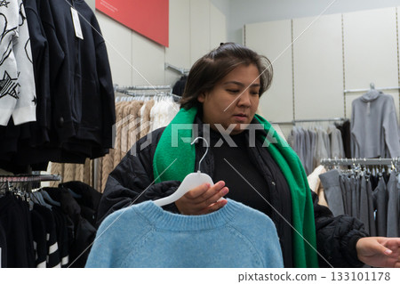 Woman Shopping for Clothes in Store Woman Shopping for Clothes in Store 133101178