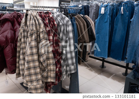Clothing racks with plaid shirts and denim jeans 133101181