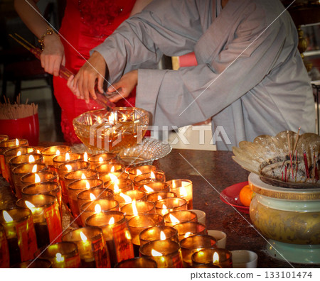 Pray in a Temple as Incense Sticks Burn, Creating a Colorful Ceremonial Scene,Chinese prayer, Chinese new year prayers Pray in a Temple as Incense Sticks Burn, Creating a Colorful Ceremonial Scene,Chinese prayer, Chinese new year prayers 133101474