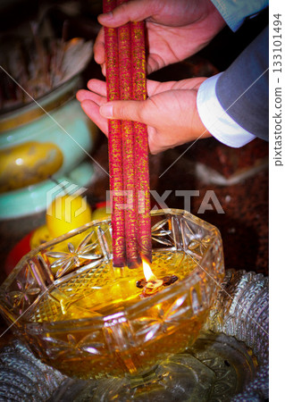 Pray in a Temple as Incense Sticks Burn, Creating a Colorful Ceremonial Scene,Chinese prayer, Chinese new year prayers Pray in a Temple as Incense Sticks Burn, Creating a Colorful Ceremonial Scene,Chinese prayer, Chinese new year prayers 133101494