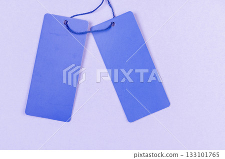 a blue empty tag for indicating the price and other information, an old clothing tag that is not filled in a blue empty tag for indicating the price and other information, an old clothing tag that is not filled in 133101765
