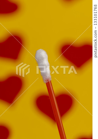 red sticks with white cotton for hygienic procedures, one red plastic sticks with natural white cotton at the ends for personal hygiene 133101768