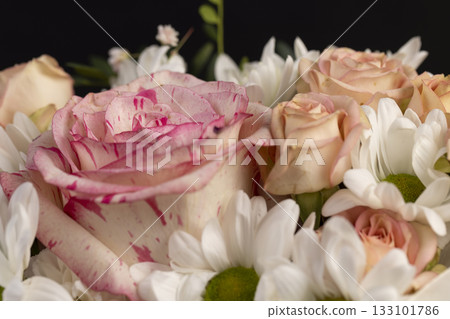 mix flowers of different colors, a flower arrangement for giving from different colors and different types of flowers 133101786
