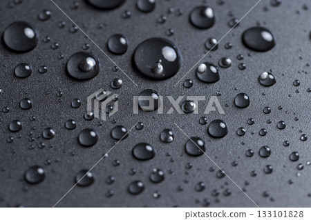 black plastic covered with water drops, details of the wet part of an object made of black plastic 133101828