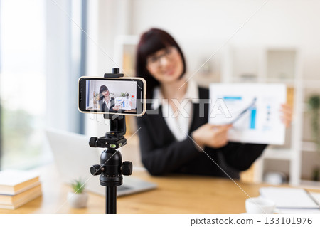 Caucasian woman recording business presentation, sharing strategies and data analysis from laptop setup Caucasian woman recording business presentation, sharing strategies and data analysis from laptop setup 133101976