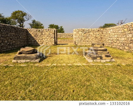 Walls and columns at Jandial temple Taxila Pakistan showing weathered stone portico 133102016