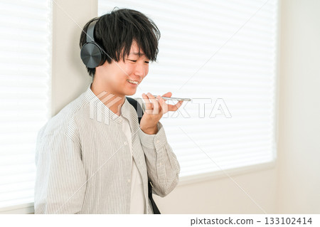 Hands-free calling on smartphone, young Asian man typing 133102414