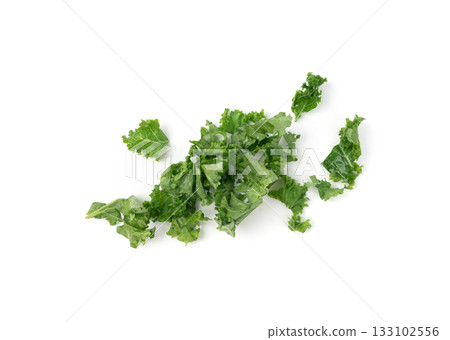 Pieces of kale cabbage leaves isolated. Green leaf of curly cabbage cooked for fresh salad Pieces of kale cabbage leaves isolated. Green leaf of curly cabbage cooked for fresh salad 133102556