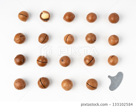 Macadamia nuts isolated. Natural raw peeled macadamia seeds and shells Macadamia nuts isolated. Natural raw peeled macadamia seeds and shells 133102584