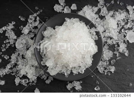 Dead sea salt pile, white crystals for body spa, sodium chloride similar to crushed ice, spa scrub 133102644