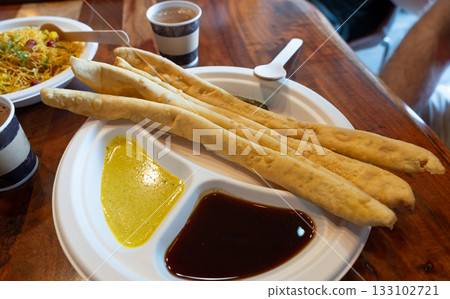 Fafda Indian snack food made from chickpea flour with spices. Faafda crispy sticks or fafda 133102721