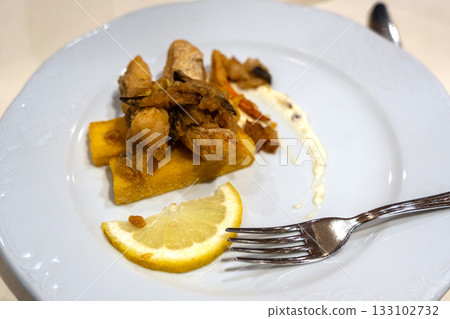 Delicious fish in batter on a restaurant plate Delicious fish in batter on a restaurant plate 133102732