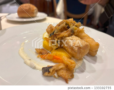 Delicious fish in batter on a restaurant plate 133102735