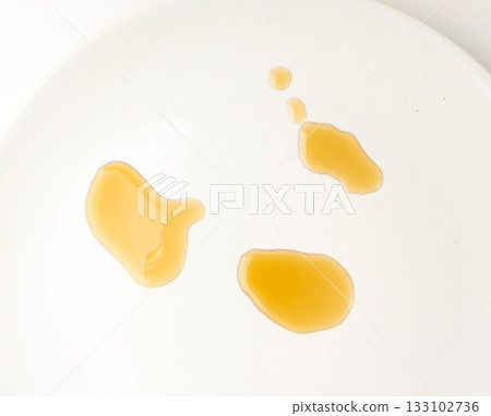 Spilled fish sauce isolated, asian fermented liquid puddle, stain, splatter, brown sauce on white Spilled fish sauce isolated, asian fermented liquid puddle, stain, splatter, brown sauce on white 133102736